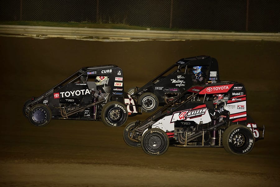 Cannon McIntosh (71k) leads Emerson Axsom (15) and Chase Johnson during Friday's POWRi Lucas Oil National Midget League feature at Charleston Speedway. (Mark Funderburk Photo)