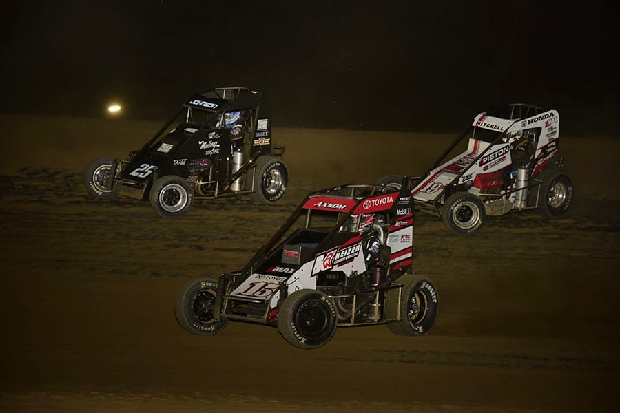 Emerson Axsom (15), Ethan Mitchell (19M) and Chase Johnson race for position during Friday's POWRi Lucas Oil National Midget League feature at Charleston Speedway. (Mark Funderburk Photo)