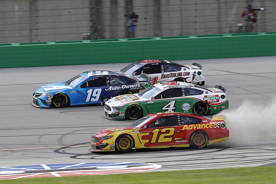 Ryan Blaney (12), Kevin Harvick (4), Martin Truex Jr. (19) and Cole Custer (41) battle four-wide for the race lead during Sunday's Quaker State 400 at Kentucky Speedway. (HHP/Harold Hinson Photo)