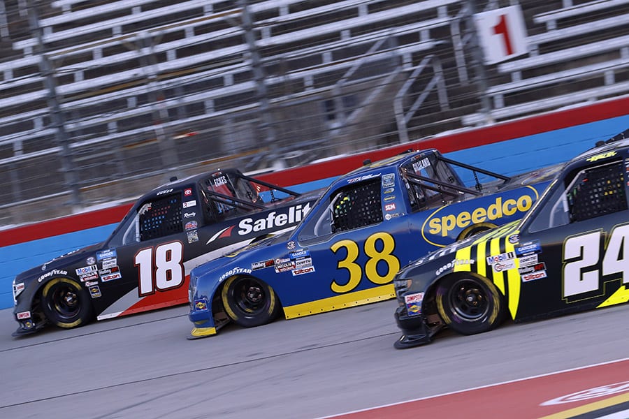 Christian Eckes (18), Todd Gilliland (38) and Justin Haley race for position during Saturday's NASCAR Gander RV & Outdoors Truck Series event at Texas Motor Speedway. (HHP/Harold Hinson Photo)