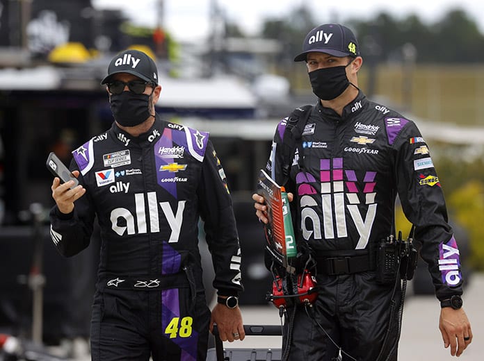 Jimmie Johnson and crew chief Cliff Daniels walk to the grid prior to the NASCAR Cup Series Folds of Honor QuikTrip 500 at Atlanta Motor Speedway on June 7. Johnson will sit out Sunday's race at Indianapolis Motor Speedway after being diagnosed with COVID-19. (Chris Graythen/Getty Images Photo)