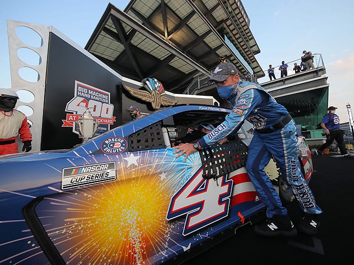 Rodney Childers, crew chief of the No. 4 Busch Light Patriotic Ford driven by Kevin Harvick, pushes the car from victory lane after winning the Big Machine Hand Sanitizer 400 Sunday at Indianapolis Motor Speedway. (Chris Graythen/Getty Images Photo)