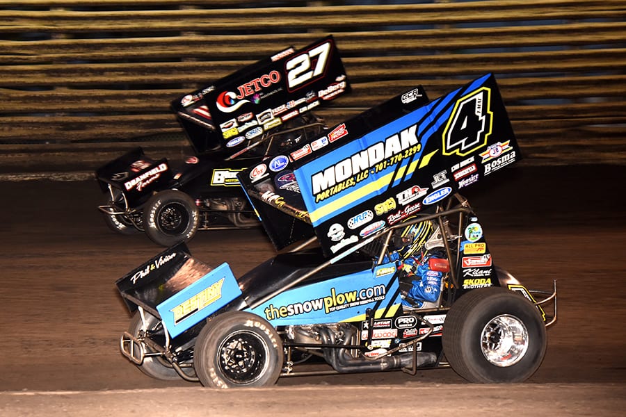 Terry McCarl (4) battles his son, Carson McCarl, during Friday's 360 Knoxville Nationals preliminary event at Knoxville Raceway. (Paul Arch Photo)