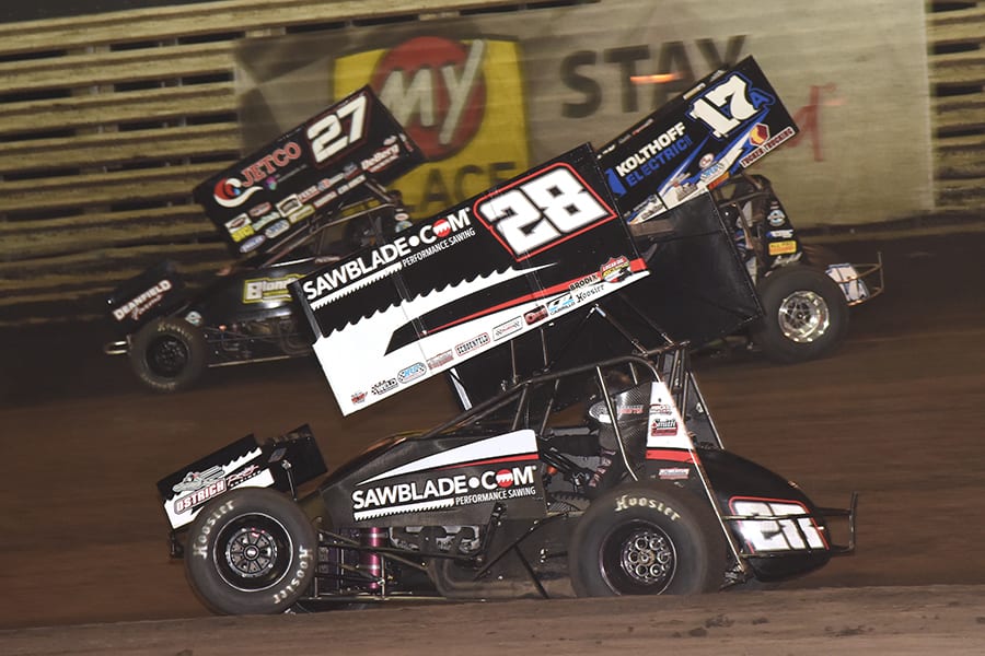 Scott Bogucki (28), Carson McCarl (27) and Austin McCarl battle for position during Saturday's 360 Knoxville Nationals finale at Knoxville Raceway. (Paul Arch Photo)