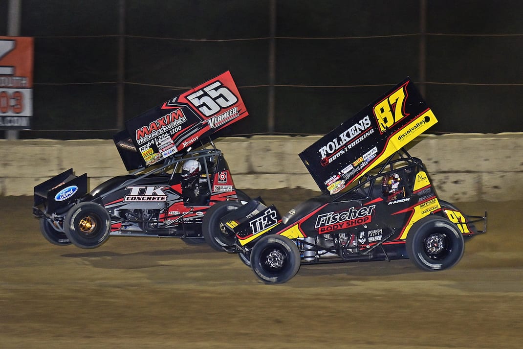 Aaron Reutzel (87) and Hunter Schurenberg battle for the lead at Plymouth Speedway. (Mike Campbell photo)