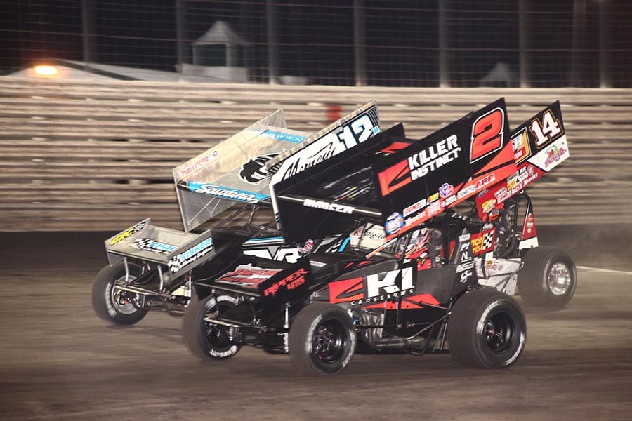 Kerry Madsen (2) battles Joey Saldana (12n) and Tim Shaffer during Saturday's 360 Knoxville Nationals finale at Knoxville Raceway. (Richard Bales Photo)