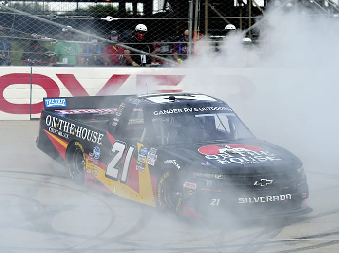 Zane Smith celebrates with a burnout after winning Friday's NASCAR Gander RV & Outdoors Truck Series race at Dover Int'l Speedway. (Jared C. Tilton/Getty Images Photo)