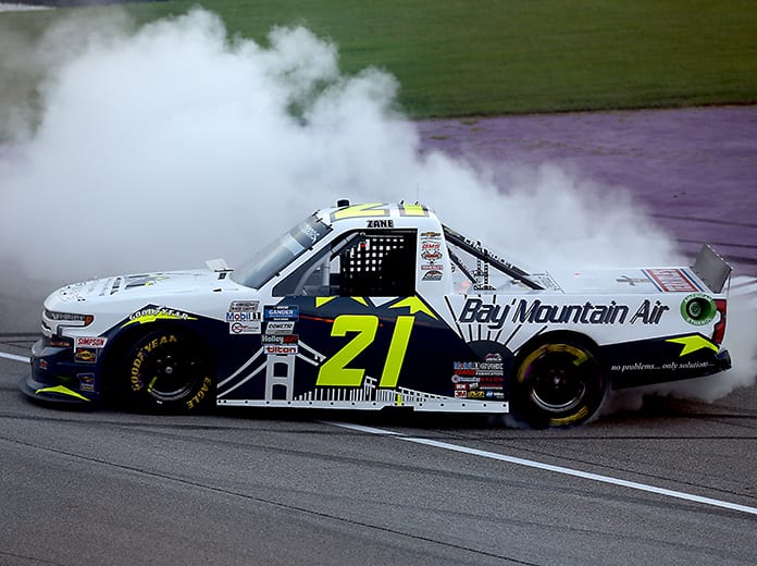 Zane Smith celebrates with a burnout after winning his first NASCAR Gander RV & Outdoors Truck Series race Friday at Michigan Int'l Speedway. (Brian Lawdermilk/Getty Images Photo)