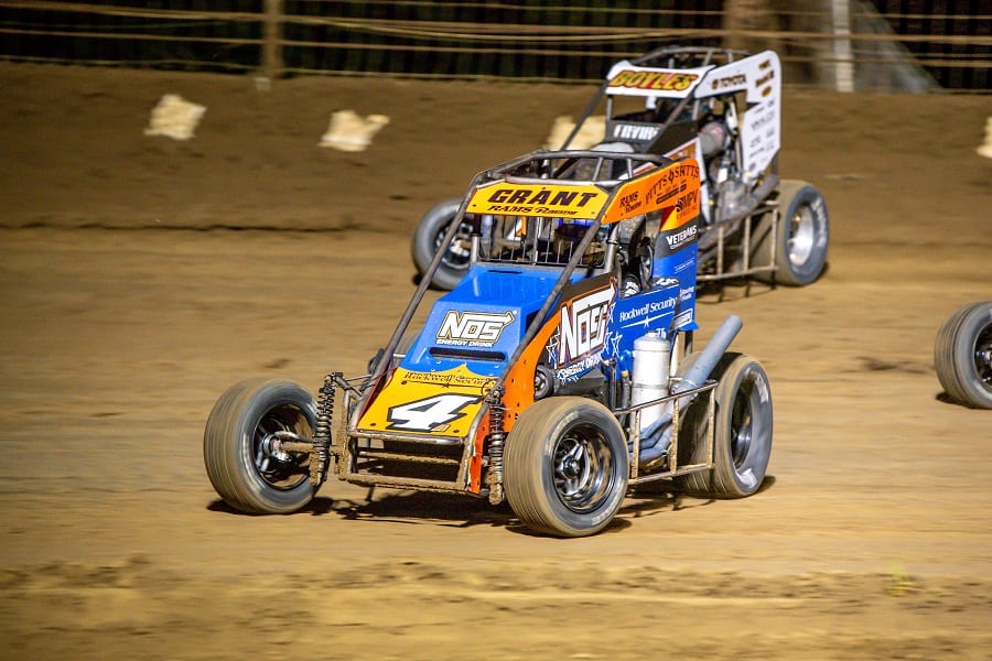 Justin Grant (4) dives underneath Clinton Boyles during Saturday's USAC National Midget Series feature at Sweet Springs Motorsports Complex. (Mark Coffman photo)