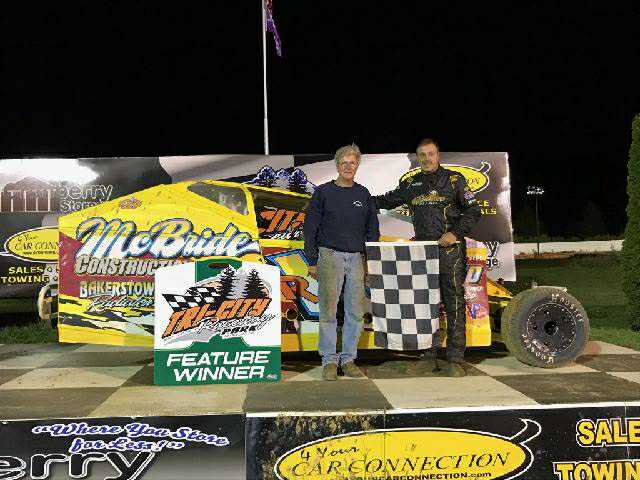 Rick Regalski (right) celebrated on the 4-Your-Car-Connection Victory Lane Stage after the Non-Winners' Race for Small Block Modified race cars on the opening night of the Applefest Race Weekend at Tri-City Raceway Park.