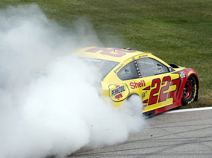 Joey Logano celebrates with a burnout after winning Sunday's Hollywood Casino 400. (HHP/Andrew Coppley Photo)