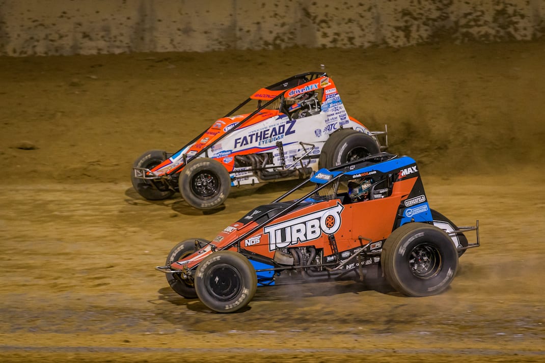 Tyler Courtney (7) and Brady Bacon battle for the lead at Lawrenceburg Speedway. (Dallas Breeze photo)