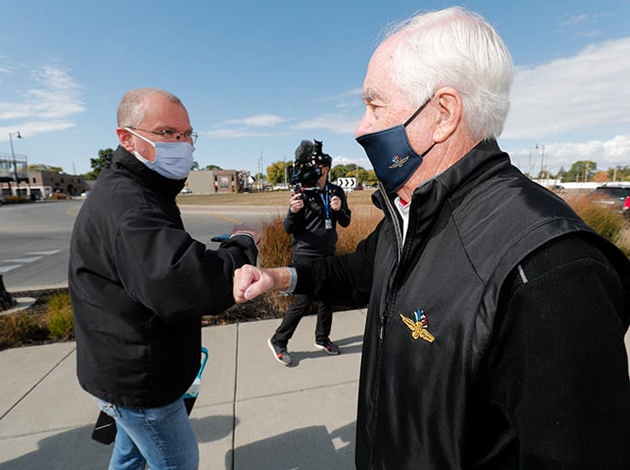 Roger Penske welcomes a fan at the Indianapolis Motor Speedway front gates Thursday. (IndyCar Photo)