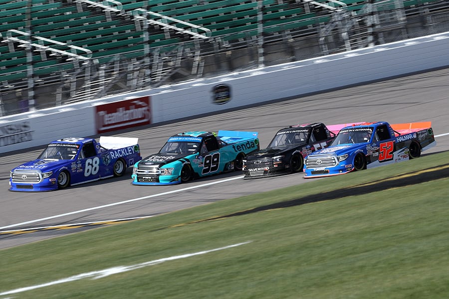 Clay Greenfield (68), Ben Rhodes (99), Tyler Hill (56) and Timothy Peters (52) race four-wide during Saturday's NASCAR Gander RV & Outdoors Truck Series race at Kansas Speedway. (Chris Graythen/Getty Images Photo)