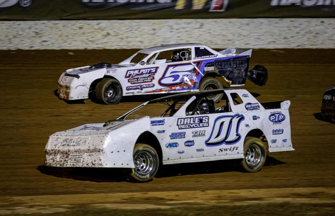 Peyton Taylor (01) passes Heath Philpot for the lead in Dash 1 on Friday night at Lucas Oil Speedway. Taylor earned the pole for Saturday night's Big Buck 50 Presented by Whitetail Trophy. (GS Stanek photo)