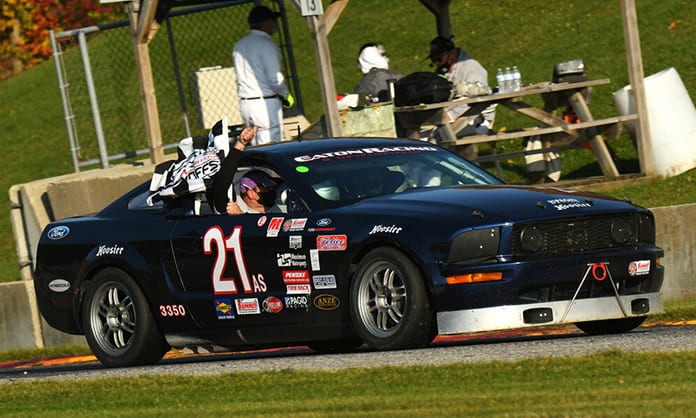 Gregory Eaton celebrates his win in the American Sedan division Saturday during the SCCA National Championship Runoffs.