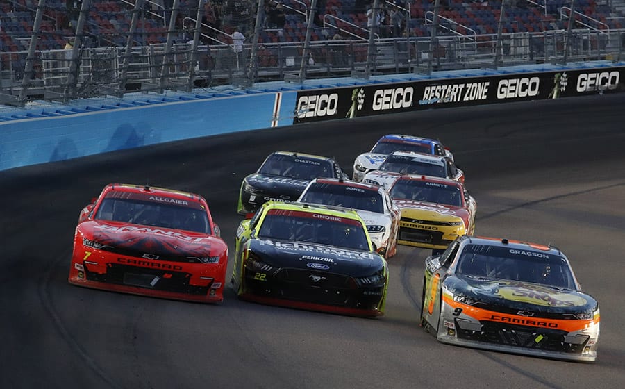 Noah Gragson (9), Austin Cindric (22) and Justin Allgaier (7) battle for the lead Saturday at Phoenix Raceway. (HHP/Andrew Coppley Photo)