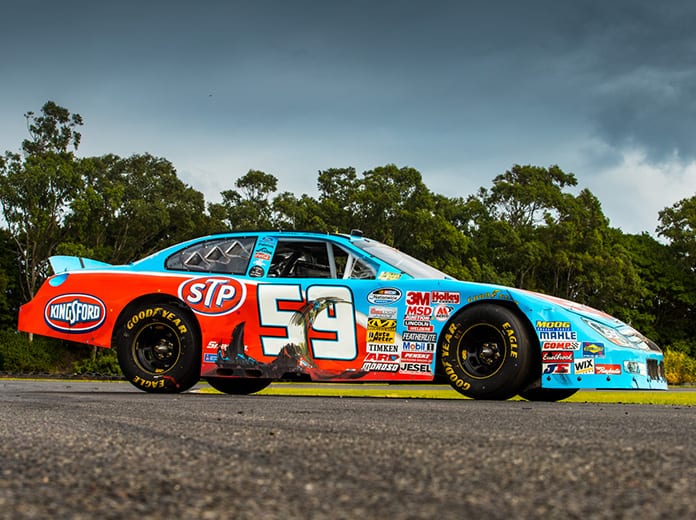 The race car Marcos Ambrose drove to his first NASCAR victory is going up for auction in Australia.