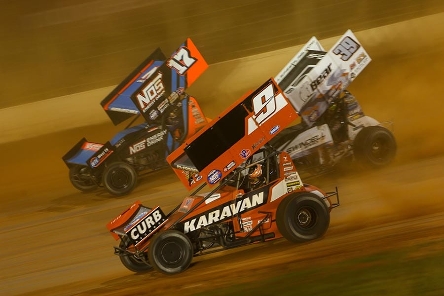 James McFadden (9), Sheldon Haudenschild (17) and Spencer Bayston battle for position during Saturday's World of Outlaws NOS Energy Drink Sprint Car Series event at The Dirt Track at Charlotte. (Adam Fenwick Photo)