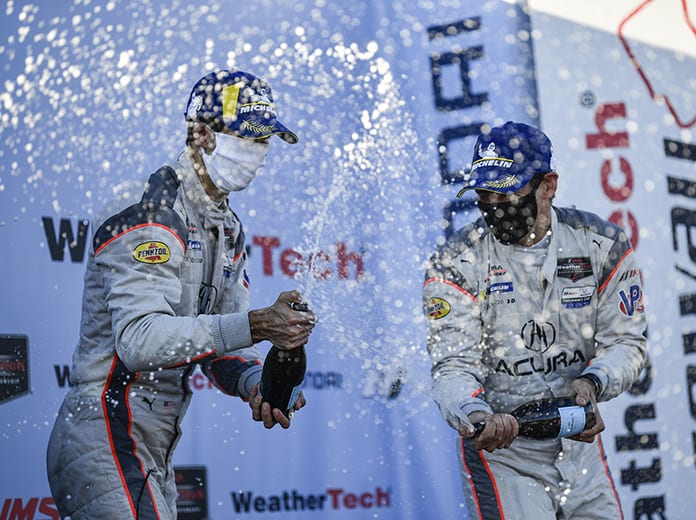 Ricky Taylor and Helio Castroneves celebrate after their victory in the Hyundai Monterey Sports Car Championship at WeatherTech Raceway Laguna Seca. (IMSA Photo)