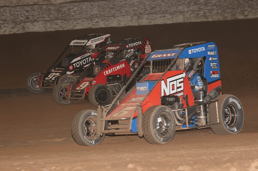 Justin Grant (5), Daison Pursley (9) and Brenham Crouch battle three-wide during the USAC NOS Energy Drink National Midget Series portion of Friday's Western World Championship preliminary event at Arizona Speedway. Ivan Veldhuizen Photo)