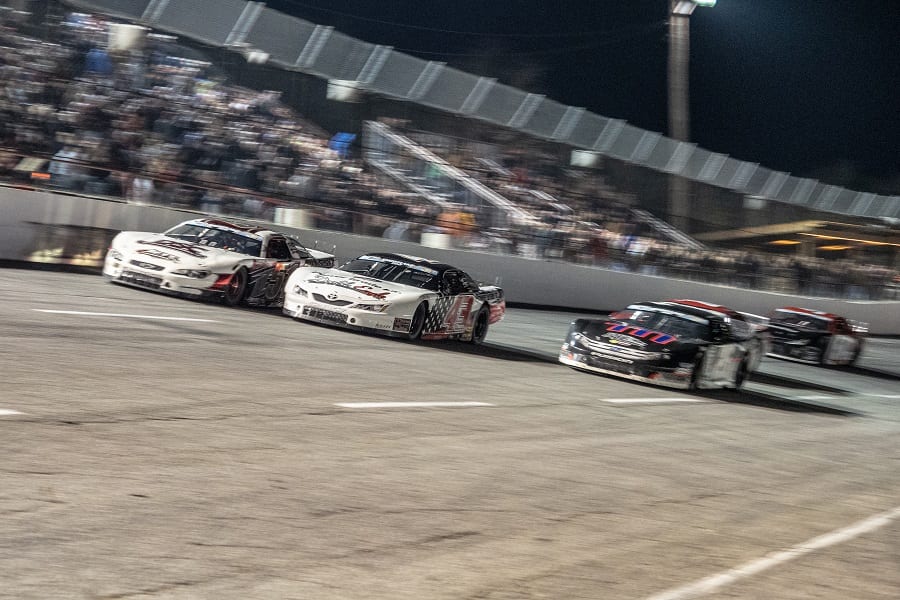 Stephen Nasse (51), Bubba Pollard (26) and Derek Thorn (43) race three-wide for the lead during the Snowflake 100 Saturday at Five Flags Speedway. (Jason Reasin Photo)