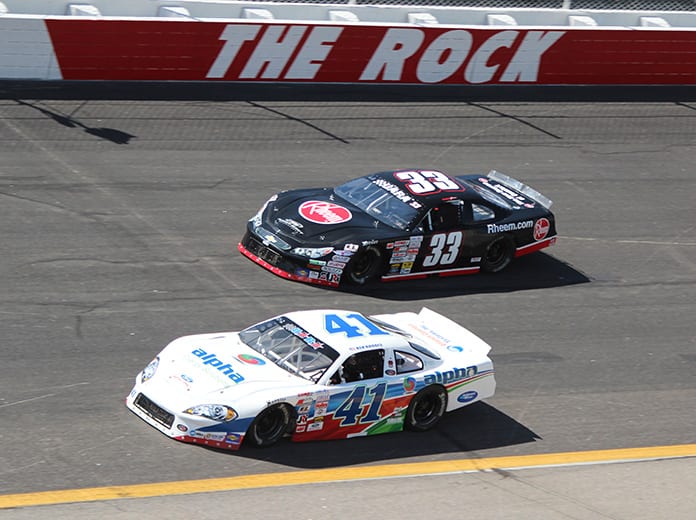 Ben Rhodes (41) and Brandon Jones (33) battle during a late model stock car race at Rockingham Speedway in 2013. The planned return to racing at Rockingham Speedway has been postponed from March 6 to Oct. 30. (Adam Fenwick Photo)