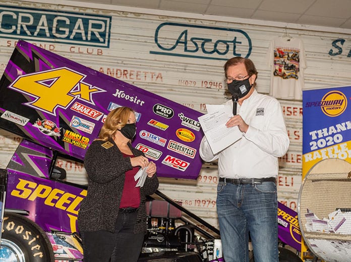 Bob Baker and Laci White of the National Sprint Car Hall of Fame & Museum draw the winner of the sprint car raffle benefiting the museum (Dave Hill Photo)