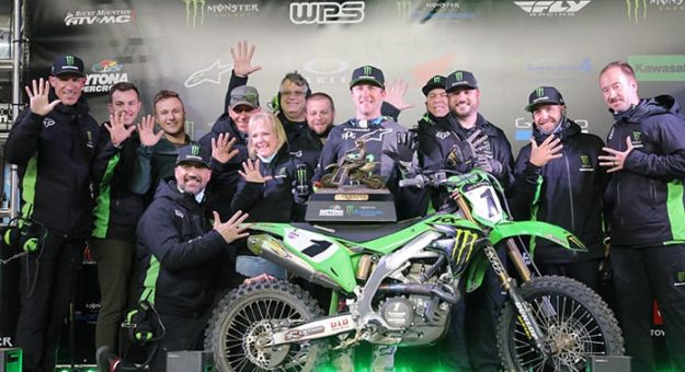 Eli Tomac poses in victory lane with his team after winning his fifth Daytona Supercross event.