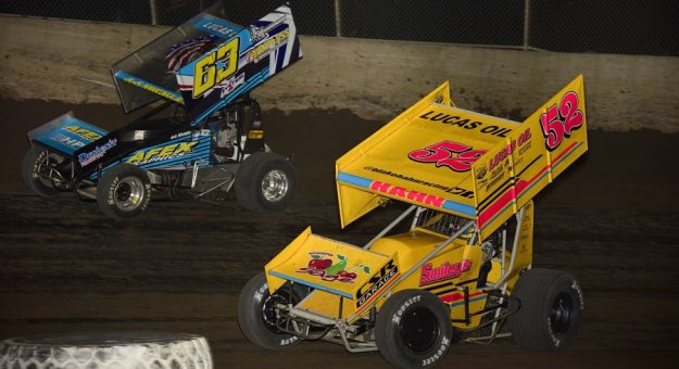 Blake Hahn (52) races underneath J.J. Hickle during Friday's Lucas Oil ASCS National Tour race at Tri-City Speedway. (Mark Funderburk photo)