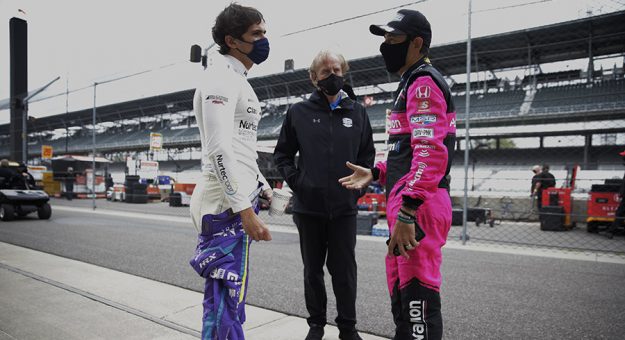 Arie Luyendyk (center) talks with Pietro Fittipaldi (left) and Helio Castroneves (right) recently at Indianapolis Motor Speedway. (IndyCar Photo)