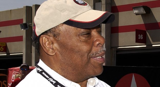 HAMPTON, GA - MARCH 20:  Chief diversity officer for Roush Racing Sam Belnavis and former heavy weight champion Evander Holifield in the garage area prior to the NASCAR Nextel Cup Series Golden Corral 500 on March 20, 2005 at the Atlanta Motor Speedway in Hampton, Georgia.  (Photo By Rusty Jarrett/Getty Images)