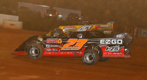 Cory Hedgecock (23) passes Donald McIntosh Friday at 411 Motor Speedway. (Michael Moats Photo)