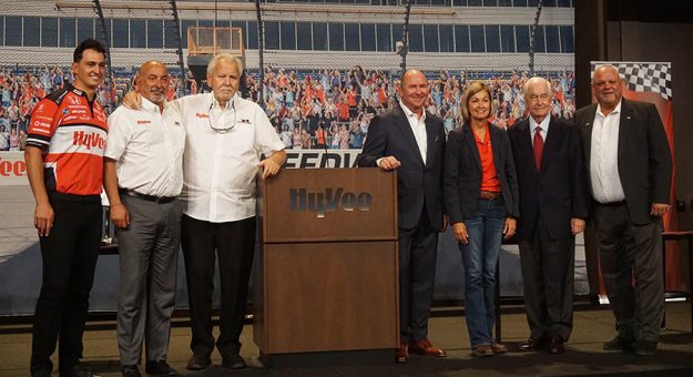(From left) Graham Rahal, Bobby Rahal, Michael Lanigan, Hy-Vee Chairman, President and CEO Randy Edeker, Iowa Governor Kim Reynolds, IndyCar owner Roger Penske and Newton Mayor Michael L. Hansen at the Iowa Speedway press conference Thursday. (Bruce Martin Photo)