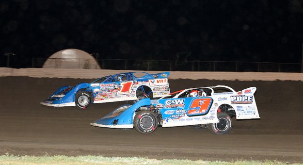 Brandon Sheppard (1) works the outside around Devin Moran during Saturday’s World of Outlaws Morton Building Late Model Series finale at Davenport (Iowa) Speedway.
