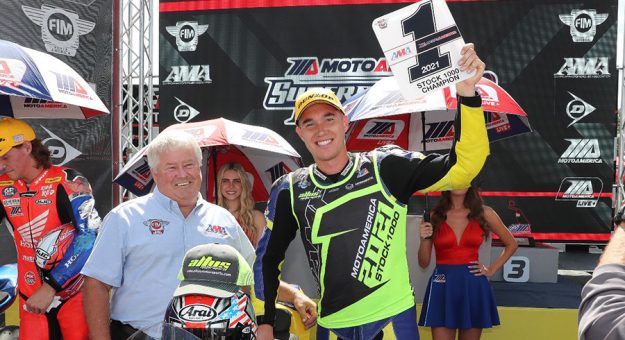 The AMA's Mike Burkeen presented Jake Lewis with his Stock 1000 number-one plate on Saturday. (Brian J. Nelson Photo)