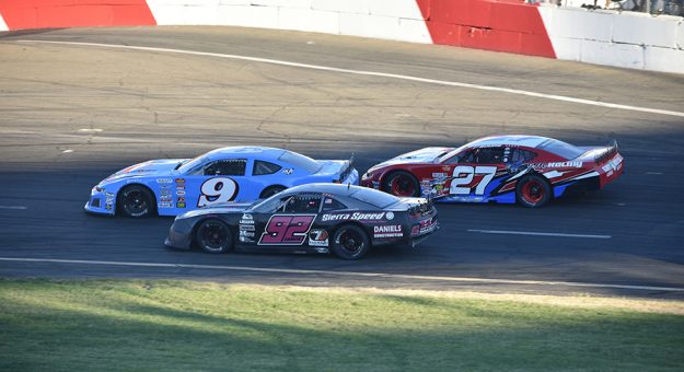Dylan Zampa (No. 92) pass for the lead in the first main event Saturday at All American Speedway. (Don Thompson Photo)