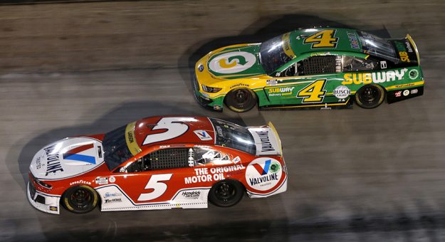 BRISTOL, TENNESSEE - SEPTEMBER 18: Kyle Larson, driver of the #5 Valvoline Chevrolet, and Kevin Harvick, driver of the #4 Subway Delivery Ford, race during the NASCAR Cup Series Bass Pro Shops Night Race at Bristol Motor Speedway on September 18, 2021 in Bristol, Tennessee. (Photo by Brian Lawdermilk/Getty Images) | Getty Images