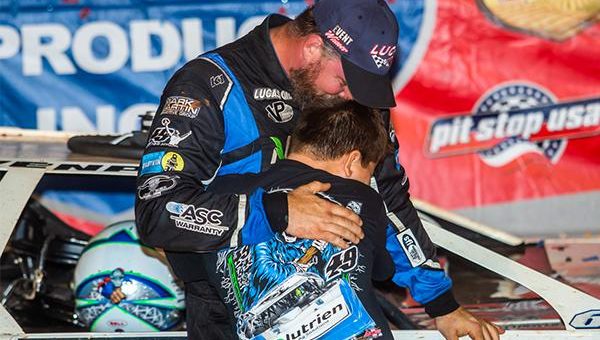 Jonathan Davenport hugs his son after winning Sunday at Rome Speedway.