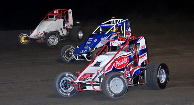 Jason McDougal (5m) battles Shane Cockrum (24) and Scotty Weir during Satuday's non-winged 410 sprint car nightcap at Gas City I-69 Speedway. (Randy Crist Photo)