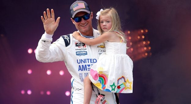 Dale Earnhardt Jr. carries daughter Isla Rose on stage during pre-race ceremonies prior to the NASCAR Xfinity Series Go Bowling 250 at Richmond Raceway on Sept. 11. (Sean Gardner/Getty Images)