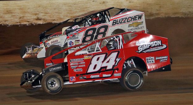 Alex Yankowski (84Y) races under Mat Williamson (88) during Friday night’s Super DIRTcar Series feature during the NGK NTK World Finals at The Drit Track at Charlotte Motor Speedway. (Jim Denhamer Photo)