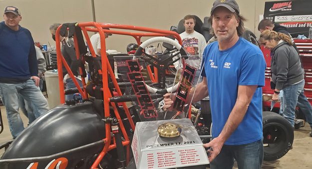 Friday midget winner Russ Gamester poses with the winner's trophy following the opening night of the 23rd Rumble in Fort Wayne.