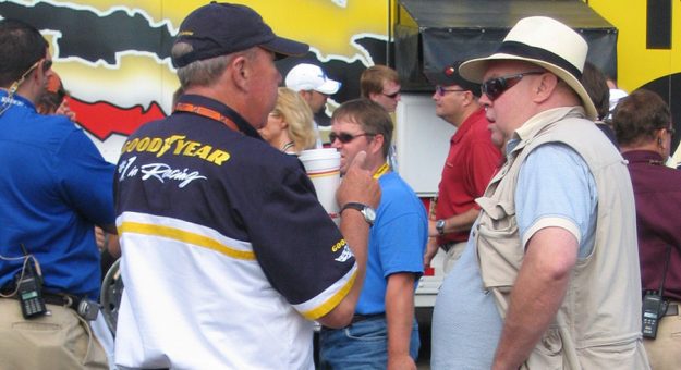 Philip A. Holmer (left) speaks with retired motorsports journalist Ed Hinton. (NASCAR Photo)