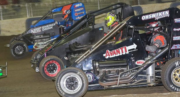 J.J. Yeley (2G), Tyler Edwards (73B) and Ricky Stenhouse Jr. race three-wide during a 2021 Chili Bowl preliminary event. (Brendon Bauman Photo)