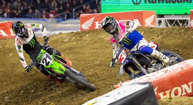 Eli Tomac (3) charges under Jason Anderson Saturday night at Detroit’s Ford Field. (Feld photo)