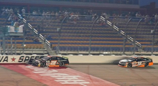 Luke Fenhaus (28) starts the last lap ahead of William Sawalich (18) during the Calypso 150 at Iowa Speedway in Newton, Iowa, featuring the Arch Menards Series 2023